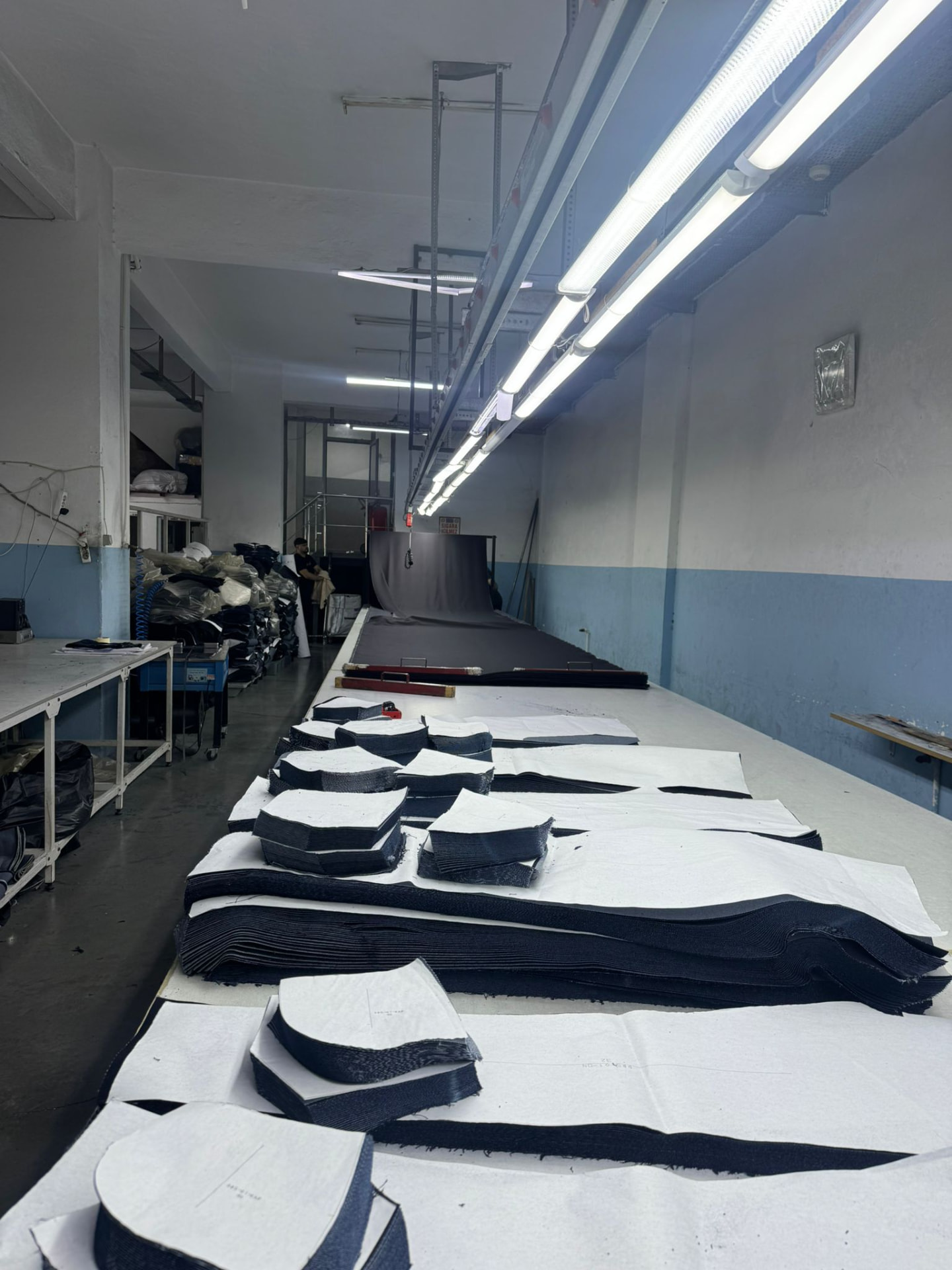 Cutting floor with spread fabric and stacked cut parts
